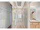 Hallway leads past the closet with mirrored sliding doors and bathroom with light colored cabinets at 10636 Argents Hill Dr, Las Vegas, NV 89134