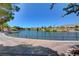 Picturesque lake view with walking path, lush landscaping and stunning mountain views at 10636 Argents Hill Dr, Las Vegas, NV 89134