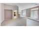 Spacious living room featuring neutral paint, large windows, and carpet floors at 10636 Argents Hill Dr, Las Vegas, NV 89134