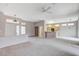 Spacious living area with open access to the kitchen, ample natural light, and ceiling fan at 10636 Argents Hill Dr, Las Vegas, NV 89134