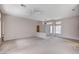 Expansive living room with neutral carpeting and walls, illuminated by natural light at 10636 Argents Hill Dr, Las Vegas, NV 89134
