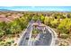 Gated community entrance with lush landscaping and well-maintained roads, offering security and beauty at 10668 Porta Romana Ct, Las Vegas, NV 89141