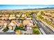 Scenic aerial view of a residential community showcasing homes with solar panels and lush landscaping at 10668 Porta Romana Ct, Las Vegas, NV 89141