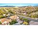 Expansive aerial view of a desert community with red tile roofs and mountain views at 10668 Porta Romana Ct, Las Vegas, NV 89141