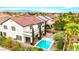 Backyard oasis featuring a pool, spa, mature landscaping, and a covered patio, perfect for relaxation at 10668 Porta Romana Ct, Las Vegas, NV 89141