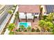 Aerial view of a home featuring a pool, spa, fire pit, and patio perfect for outdoor entertaining at 10668 Porta Romana Ct, Las Vegas, NV 89141