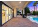 This home features a covered patio area with views of the pool and outdoor fire pit at 10668 Porta Romana Ct, Las Vegas, NV 89141