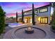 This home has an outdoor fire pit, pool, patio, balcony, and manicured landscaping at 10668 Porta Romana Ct, Las Vegas, NV 89141