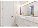 The modern bathroom features white cabinets with gold hardware and dual square vessel sinks at 10668 Porta Romana Ct, Las Vegas, NV 89141