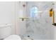 This bathroom offers a walk-in shower with marble-look tile and gold fixtures at 10668 Porta Romana Ct, Las Vegas, NV 89141
