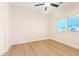 Minimalist bedroom with a ceiling fan, bright window, and light colored flooring at 10668 Porta Romana Ct, Las Vegas, NV 89141