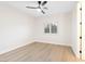 This bright bedroom has a ceiling fan, light wood floors, and window with plantation shutters at 10668 Porta Romana Ct, Las Vegas, NV 89141
