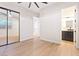 Spacious bedroom features a mirrored closet, plank floors and an attached bathroom at 10668 Porta Romana Ct, Las Vegas, NV 89141