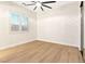 Minimalist bedroom with a large window, ceiling fan, and bright flooring at 10668 Porta Romana Ct, Las Vegas, NV 89141