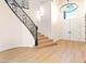 Grand entryway with an ornate staircase, high ceilings, and double doors, filled with natural light at 10668 Porta Romana Ct, Las Vegas, NV 89141