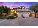 Elegant two-story home with a three-car garage, manicured lawn, and decorative stone accents at 10668 Porta Romana Ct, Las Vegas, NV 89141