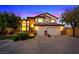 Charming two-story home featuring a well-manicured lawn, a three-car garage, and classic architecture at 10668 Porta Romana Ct, Las Vegas, NV 89141