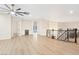 Open floor plan with plank floors, unique wall design, and decorative wrought iron railing at 10668 Porta Romana Ct, Las Vegas, NV 89141