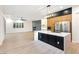 Modern kitchen with center island, fireplace, stainless steel appliances, and plenty of natural light at 10668 Porta Romana Ct, Las Vegas, NV 89141