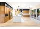 Modern kitchen with large island, stainless appliances, and sliding glass doors to the patio at 10668 Porta Romana Ct, Las Vegas, NV 89141