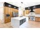 Modern kitchen with a large island, stainless steel appliances, and custom cabinetry at 10668 Porta Romana Ct, Las Vegas, NV 89141