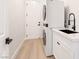 The spacious laundry room features a stacked washer/dryer and modern finishes at 10668 Porta Romana Ct, Las Vegas, NV 89141
