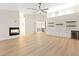 Bright living room with hardwood floors, a fireplace, built-in cabinets and shelving at 10668 Porta Romana Ct, Las Vegas, NV 89141