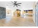 Spacious living area showcasing hardwood floors, modern lighting, and a full gourmet kitchen at 10668 Porta Romana Ct, Las Vegas, NV 89141