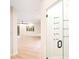 A glass mud room entry features hooks and a dark door handle for hanging coats at 10668 Porta Romana Ct, Las Vegas, NV 89141