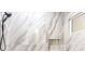 Luxurious shower features beautiful tile, niche, and modern shower head at 10668 Porta Romana Ct, Las Vegas, NV 89141