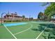 Well-maintained basketball court with green surface, white lines, and basketball hoop for recreational games at 1081 Via Gandalfi, Henderson, NV 89011