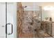 Bathroom shower featuring stone tile and bench at 1081 Via Gandalfi, Henderson, NV 89011