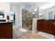 This bathroom boasts a glass shower and wood cabinets at 1081 Via Gandalfi, Henderson, NV 89011
