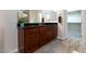 Bathroom vanity with dark countertop and wood cabinets at 1081 Via Gandalfi, Henderson, NV 89011