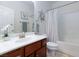 Bathroom with single vanity, white tub, and decorative flower accents at 1081 Via Gandalfi, Henderson, NV 89011