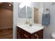 Bathroom features a single vanity, decorative light fixture, and wood floors at 1081 Via Gandalfi, Henderson, NV 89011