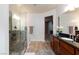 Bathroom vanity with dark countertop and wood cabinets at 1081 Via Gandalfi, Henderson, NV 89011