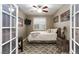 Bedroom with a ceiling fan, bed, and a window for natural light at 1081 Via Gandalfi, Henderson, NV 89011