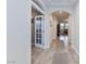 Hallway with wood floors and view through glass doors to other rooms at 1081 Via Gandalfi, Henderson, NV 89011