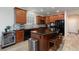 Modern kitchen with stainless steel appliances, a breakfast bar, and ample cabinet space at 1081 Via Gandalfi, Henderson, NV 89011