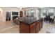 Open concept featuring kitchen island transitioning into living room with natural light at 1081 Via Gandalfi, Henderson, NV 89011
