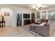 Spacious living room with a sectional couch, television, and wood floors at 1081 Via Gandalfi, Henderson, NV 89011