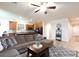 Spacious living room with hardwood floors, comfortable seating, and an adjacent kitchen at 1081 Via Gandalfi, Henderson, NV 89011