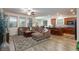Spacious living room with a sectional couch, wood floors, and a kitchen at 1081 Via Gandalfi, Henderson, NV 89011