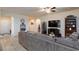 Bright living room featuring hardwood floors, comfortable seating, and stylish decor at 1081 Via Gandalfi, Henderson, NV 89011