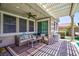 Inviting covered patio with wicker furniture, a ceiling fan, and access to the backyard, ideal for outdoor living at 1081 Via Gandalfi, Henderson, NV 89011