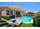 Beautiful backyard featuring a sparkling pool, lounge chairs, and a covered patio perfect for entertaining at 1081 Via Gandalfi, Henderson, NV 89011
