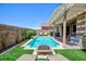 Inviting backyard pool and spa area featuring a fire pit and lush landscaping for relaxation and enjoyment at 1081 Via Gandalfi, Henderson, NV 89011
