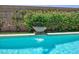 Close-up of the backyard pool waterfall feature, adding a touch of elegance and tranquility to the outdoor space at 1081 Via Gandalfi, Henderson, NV 89011