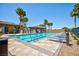 Community swimming pool surrounded by lounge chairs, palm trees, and covered seating areas at 1081 Via Gandalfi, Henderson, NV 89011